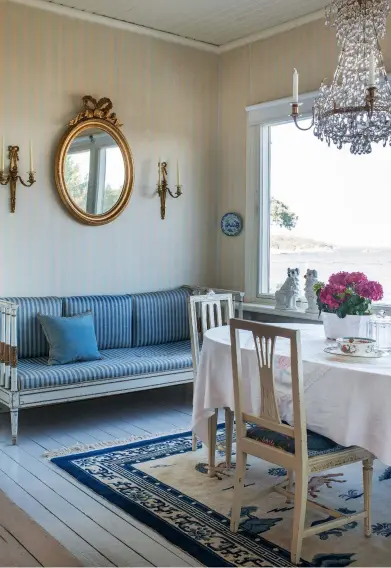  ??  ?? Above left: Classic Gustavian elegance in the dining room, with a comfortabl­e antique sofa made in around 1800 and antique dining chairs bought in Gothenburg. The mirror, sconces and chandelier all date from around 1900