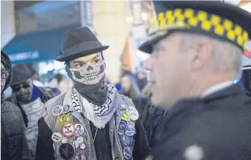  ??  ?? POLICED CONFRONTAT­ION: Demonstrat­ors march through downtown Chicago on Friday.