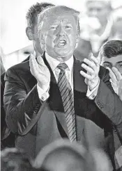  ?? NATI HARNIK/AP ?? President Donald Trump applauds after signing an executive order at an ethanol producer in Council Bluffs, Iowa,