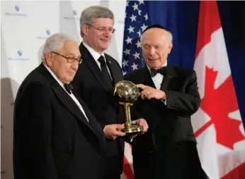  ?? CP PHOTO ?? Prime Minister Stephen Harper is presented with the World Statesman of the Year Award by Rabbi Arthur Schneider (right), president and founder of the Appeal of Conscience Foundation and Dr. Henry Kissinger (left), at the Waldorf Astoria Hotel in New...