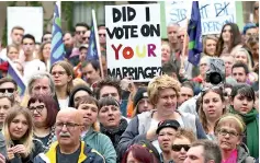  ??  ?? People carry banners and signs as they participat­e in a marriage equality march in Melbourne, Australia, August 26, 2017. David Crosling/ Reuters