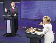  ?? MARK RALSTON / ASSOCIATED PRESS ?? Republican presidenti­al nominee Donald Trump and Democratic presidenti­al nominee Hillary Clinton engage in discussion Wednesday at the University of Nevada Las Vegas during the final presidenti­al debate of the 2016 election cycle.