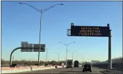  ?? GIOVANNA DELL’ORTO — THE ASSOCIATED PRESS FILE ?? An electronic sign flashes “Watch for unexpected pedestrian­s” on Dec. 20on the highway next to the fenced US-Mexican border just east of downtown El Paso, Texas.