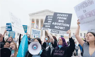  ?? ANNA MONEYMAKER/GETTY ?? Activists demonstrat­e Tuesday in front of the U.S. Supreme Court building in Washington.