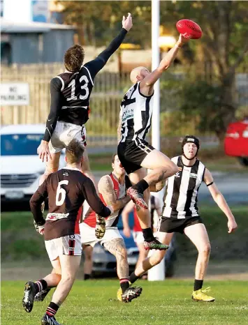  ?? ?? Poowong’s Patrick Harmes palms from Nyora’s Travis Stewart. Stewart was named in Noyra’s best while Harmes kicked a goal.