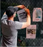  ?? AP ?? Photos of missing persons are attached to a fence in Surfside, Florida, after the collapse of a 12-storey building.