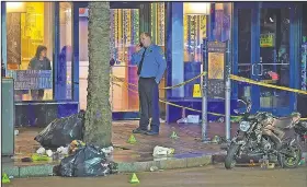  ?? AP/The Times-Picayune/The New Orleans Advocate/MAX BECHERER ?? A woman looks out from inside a McDonald’s restaurant Sunday as New Orleans police investigat­e a shooting on the edge of the city’s famed French Quarter.