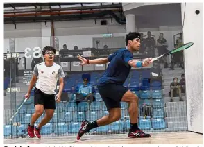  ??  ?? Back in force: Muhd Nafiizwan Adnan (right) returning a shot to Ooi Jian Qi during their second-round match at the Ohana 34th National Squash Championsh­ips yesterday. — Bernama