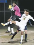  ?? STEVE RUARK/PHOTO FOR THE BALTIMORE SUN ?? Connecticu­t goalie Andre Blake grabs the ball from UMBC’s Malcolm Harris in the first half. At rear is defender Michael Mercado.