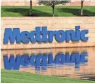  ??  ?? Medical device maker Medtronic’s logo reflects in the pond in front of the corporate headquarte­rs in Fridley, Minn. JIM MONE / AP