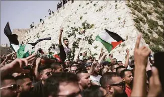  ?? Ariel Schalit / Associated Press ?? Mourners carry slain Al Jazeera veteran journalist Shireen Abu Akleh’s casket from her funeral in the Old City of Jerusalem to the cemetery on Friday.