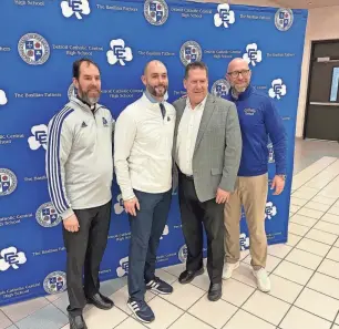  ?? BRAD EMONS/SPECIAL TO DETROIT FREE PRESS ?? New Detroit Catholic Central football coach Justin Cessante (second from left) was introduced. He is standing with (from left) CC principal Fr. Patrick Fulton, school president Edward Turek and athletic director Aaron Babicz.