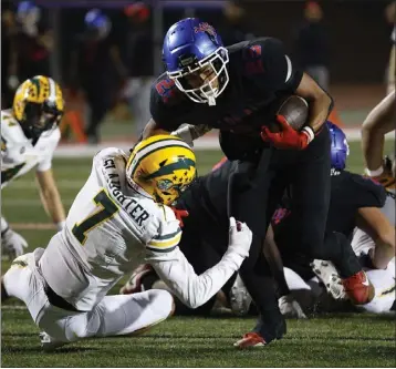  ?? PHOTOS BY TRACEY ROMAN ?? Los Alamitos' Anthony League pushes past Edison's Gavin Slaughter to score a touchdown in Friday night's game.