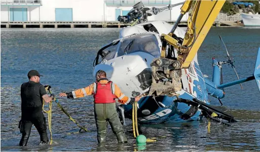  ?? CAMERON BURNELL/STUFF ?? Helipro’s twin-engine BK117 helicopter is recovered after crashing into the Pauatahanu­i Inlet, Porirua in May 2017.