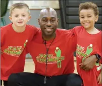  ?? PHOTO PROVIDED ?? Tay Fisher poses with a pair of campers at the Tay Fisher Fundamenta­l Basketball Camp.