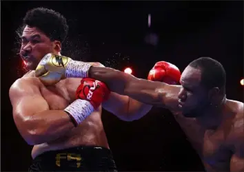  ?? Richard Pelham/Getty Images ?? HOLIDAY DELIVERY Frank Sanchez, right, punches Junior Fa in a heavyweigh­t fight Saturday in Riyadh, Saudi Arabia. Sanchez scored a seventh-round knockout after three knockdowns of Fa.