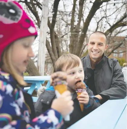  ?? ALLEN McINNIS ?? Montreal Impact goalkeeper Evan Bush watches as his children, Isabella and Canaan, enjoy an ice cream at Wild Willy’s in Pointe-Claire, this week. In his ninth season, the 33-year-old Bush is the longest tenured player on the team.