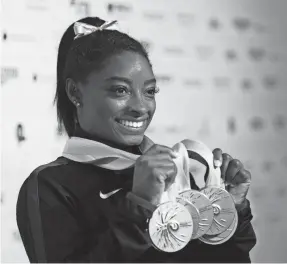  ?? LAURENCE GRIFFITHS/GETTY IMAGES ?? Simone Biles’ collection of world gymnastics medals is at 25.