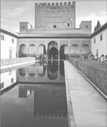  ??  ?? This photo shows tourists in a courtyard at The Alhambra in Granada, Spain.