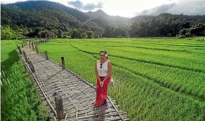  ?? PHOTOS: SARAH WILLIAMS ?? Sarah Williams among the rice fields of Thailand.