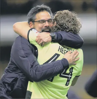  ?? PICTURE: BRUCE ROLLINSON ?? WE DID IT: Huddersfie­ld Town’s head coach David Wagner hugs Michael Hefele after the final whistle at Molineux.