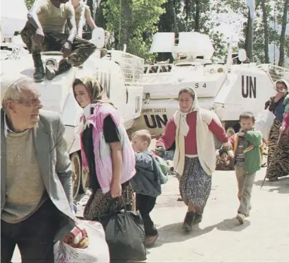  ??  ?? 0 Bosnian Muslim refugees from Srebrenica seek refuge at a UN base in Potocari in July 1995