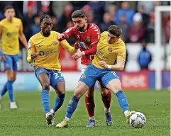  ?? ?? ■ Above, Elliot Lee tussles with Sunderland’s Jay Matete and Lynden Gooch. Right, Arbenit Xhemajli looks to play the ball out of defence