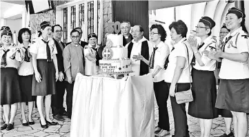  ??  ?? Council members, advisors and captains of KGC and their respective church chaplains gather around a birthday cake to celebrate the 50th year of the Girls’ Brigade 1st Kuching Company. Also seen is Chew (fourth right) and Lau (sixth left).
