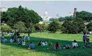  ?? NYT ?? People sit in the shade of the Washington Monument on a hot Saturday afternoon. Midsummer-like temperatur­es are predicted this weekend, with blazing heat and humidity.