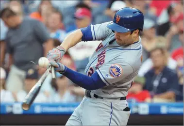  ?? USA TODAY SPORTS ?? New York Mets second baseman Neil Walker breaks his bat during his team’s MLB game against the Philadelph­ia Phillies at Citizens Bank Park on Thursday. The Mets homered four times for a 10-0 triumph.