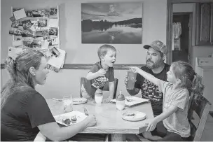  ?? MAX WHITTAKER/NEW YORK TIMES ?? Chelsea and Tanner Cassens eat a meal of elk meat with their children, Lane and Brynlee, in Imbler, Ore. Hunters are increasing­ly making the transition to copper bullets amid mounting evidence that lead bullets are poisoning the wildlife that feed on carcasses and polluting the game meat that many people eat.