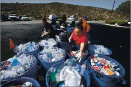  ?? MONTEREY HERALD ARCHIVE ?? Amadeysi Lopez with her mother Isabel Arango from Seaside sorts their recyclable­s while waiting in line at a recycling facility in Sand City in 2016. That facility, like many others in California, has since been closed.