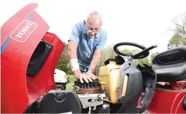  ?? STAFF PHOTO BY TIM BARBER ?? Jack Wilson diagnoses an engine problem on a riding lawnmower at his home south of Cleveland, Tenn. Jack’s Small Engine Repair has been his business since he left the Army in 1979.