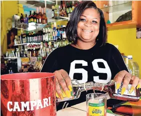  ?? KENYON HEMANS PHOTOS ?? Barmaid Subrena Schooler mixes up a glass of Rumpari for a customer.