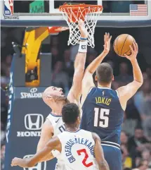  ?? Matthew Stockman, Getty Images ?? Denver’s Nikola Jokic puts up a shot against the Clippers’ Marcin Gortat on Thursdy night.