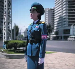  ?? Ed Jones / AFP ?? The face of Pyongyang: a ‘traffic lady’ takes control of her junction.