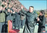  ?? ?? North Korea’s leader Kim Jong-un (second from right) and his daughter greet scientists and engineers from a defence science research institute at an unknown location.