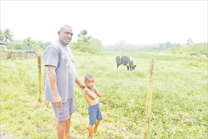  ?? Picture: JONACANI KONATACI ?? Small-scale dairy farmer Veniasi Moroca, left, with his nephew on their family farm in Naitasiri.