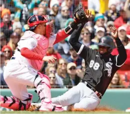  ?? GETTY IMAGES ?? Luis Robert beats the tag of Red Sox catcher Christian Vazquez to score on Jose Abreu’s double in the third inning, giving the White Sox a 3-0 lead.
