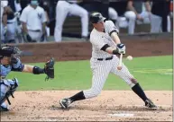  ?? Jae C. Hong / Associated Press ?? The New York Yankees’ DJ LeMahieu hits a sacrifice fly to score Brett Gardner as Tampa Bay Rays catcher Mike Zunino looks on during the second inning in Game 4 of the American League Division Series.