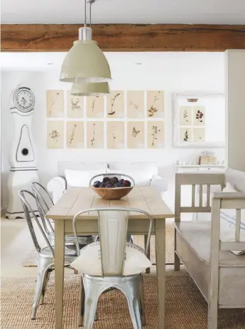  ??  ?? DINING AREA ‘Opening up this space has made it feel sociable,’ says Natalie. Antique French table and bench, £400; Swedish Mora clock, £1,200, all Haus. Metal chairs, £49 each, Cult Furniture