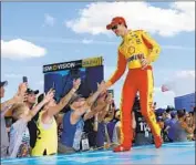  ?? Terry Renna Associated Press ?? JOEY LOGANO, NASCAR’s reigning Cup series champion, greets fans before the Daytona 500.