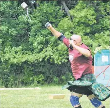  ?? KEVIN ADSHADE/THE NEWS ?? Scott McHugh throws a 28-pound weight across Tartan Field.