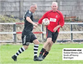  ??  ?? Hometown star Robbie Winters, left, fends off Kenny Brannigan