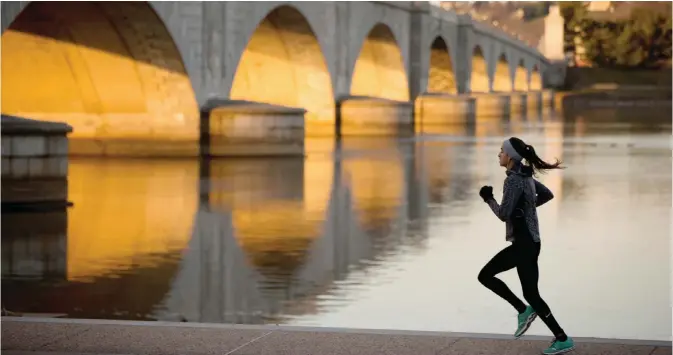  ??  ?? WASHINGTON: In this March 3, 2016 file photo, a jogger passes by the Arlington Memorial Bridge at sunrise in Washington. Donald Trump talked during his campaign about making America’s infrastruc­ture great again, and his inaugurati­on will put the...