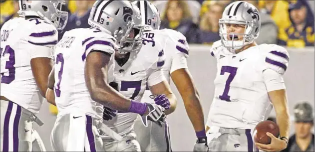  ?? Photo by Getty ?? Collin Klein and Kansas State have plenty to celebrate as Wildcats run wild over reeling West Virginia, which is finding life in Big 12 a bit tougher than ruling the Big East.