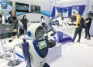  ??  ?? FACING THE FUTURE: A police robot that can scan faces at the China Internatio­nal Exhibition on Police Equipment in Beijing, left. CALL TO ARMS: Weapons on display at the China Internatio­nal Exhibition on Police Equipment, right.