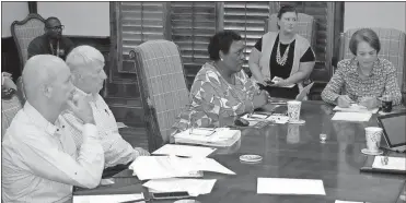  ?? / Doug Walker ?? The Northwest Georgia Housing Authority board learned Tuesday that its developmen­t partner for the Altoview Terrace replacemen­t apartments has proposed a significan­tly lower budget than the architects believe is realistic. Seated around the board table are architects Bruce Mitchell (from left), Don Dorsey, NWGHA Director Sandra Hudson and Authority Chairwoman Lee Hight.