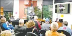  ?? Photo submitted ?? At the Bella Vista Library recently, author and cryptozool­ogist Lyle Blackburn talks all about the Beast of Boggy Creek that roams around in Arkansas.