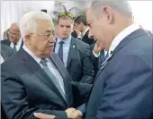  ??  ?? Israeli prime minister Benjamin Netanyahu, right, greets Palestinia­n president Mahmoud Abbas during the state funeral of former Israeli president Shimon Peres at Mount Herzl Military Cemetery in Jerusalem yesterday.